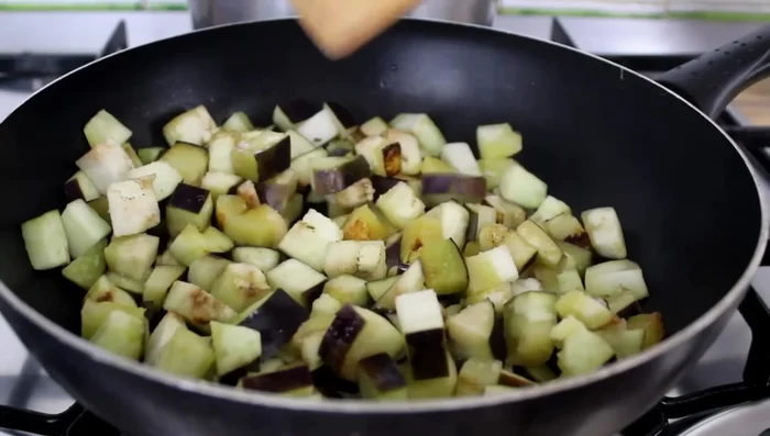 Make the aubergine sauce: Add 400g tomato paste, a little water, salt, and 2 basil leaves to the aubergine. Simmer until the sauce is reduced (15-20 mins).