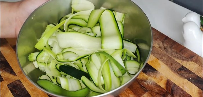 Preheat oven and prepare zucchini. (This step is inferred from the audio and video context, as the transcript only contains music)