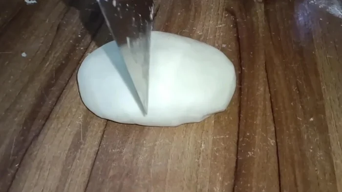 Divide the dough into two equal parts, shape into balls, and let rest in the fridge for an hour.