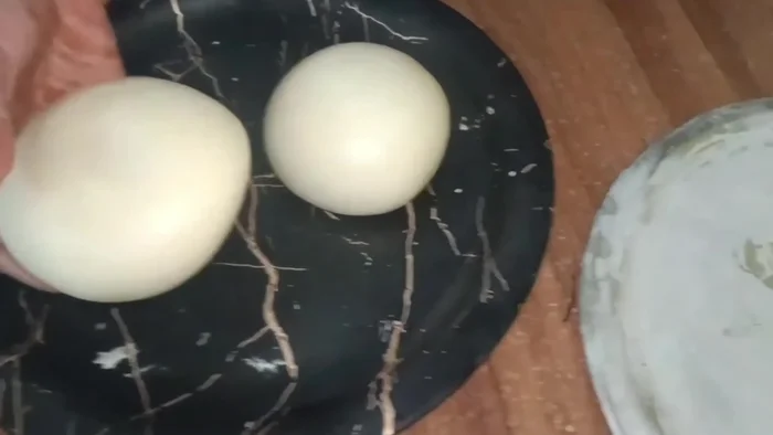 Lightly oil and flour two plates. Roll out each dough ball to form a thick-crusted, thin-centered pizza base. Brush with oil and milk wash.