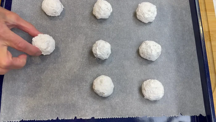 Place dough balls on a baking tray, spaced out evenly.