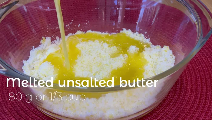 Add melted unsalted butter, vanilla extract, and lemon juice to the bowl. Stir.