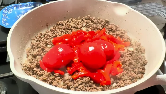 Add 1 jar of roasted red peppers, whole peeled tomatoes, 1 tablespoon of minced garlic, and 1 1/2-2 cups of beef broth (or equivalent).