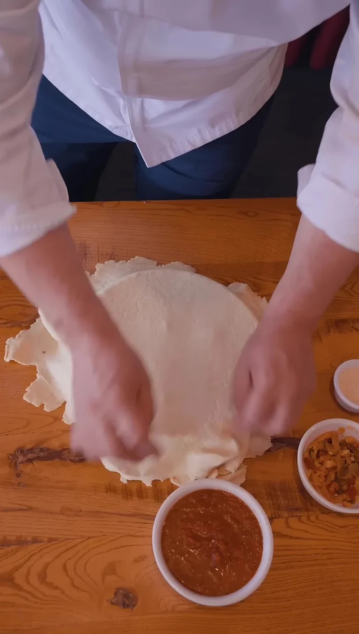 Top with another layer of Giordano's pizza dough; poke holes to prevent exploding.