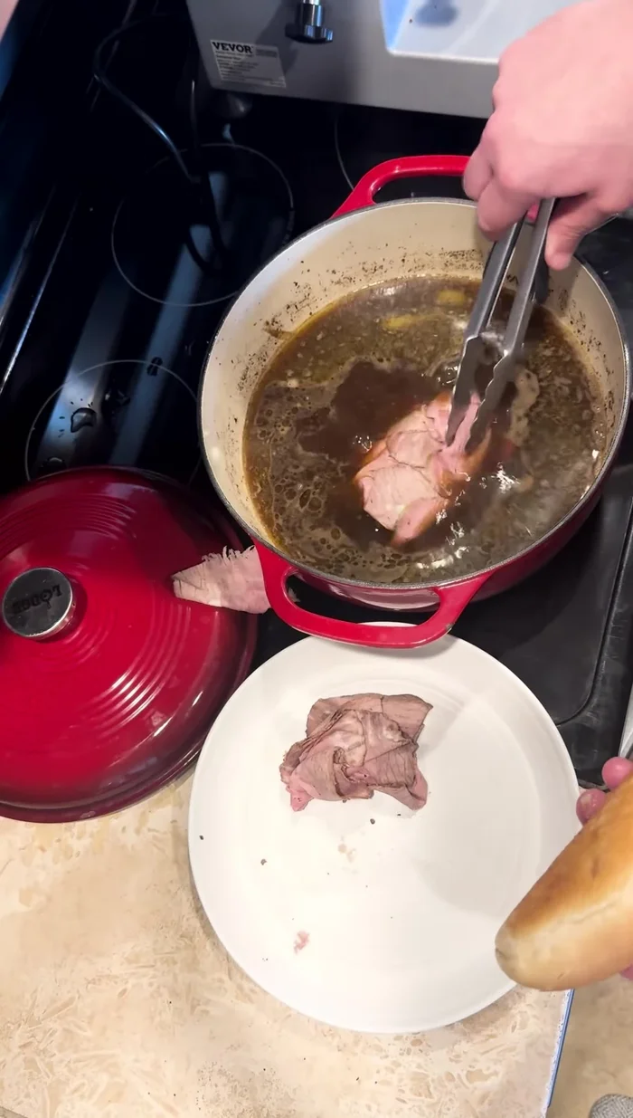 Warm the sliced beef in au jus.