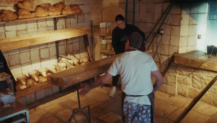 Load the loaves: Carefully place the shaped loaves into the preheated oven using a long wooden paddle.