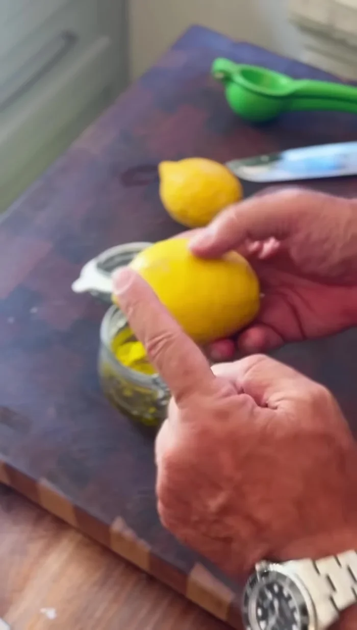 Zest two lemons and add the zest to the jar.