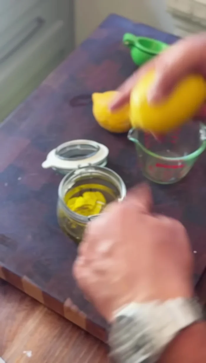 Juice the two lemons and add the juice to the jar.