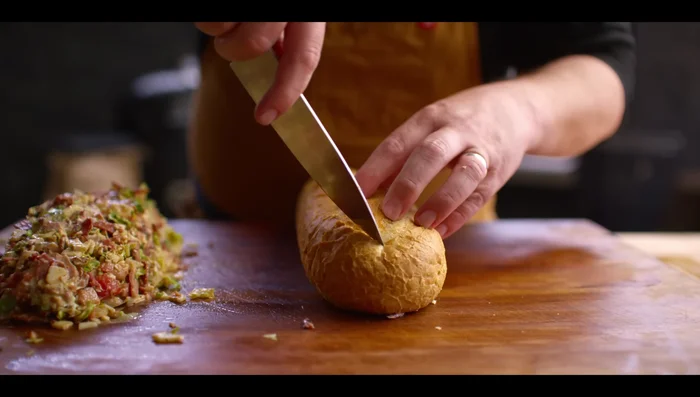 Hollow out a French loaf, leaving enough room for the filling. (166.959)