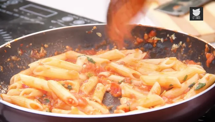 Add cooked pasta to the sauce, ensuring it absorbs the flavor. Add a bit of olive oil for glaze and aroma.