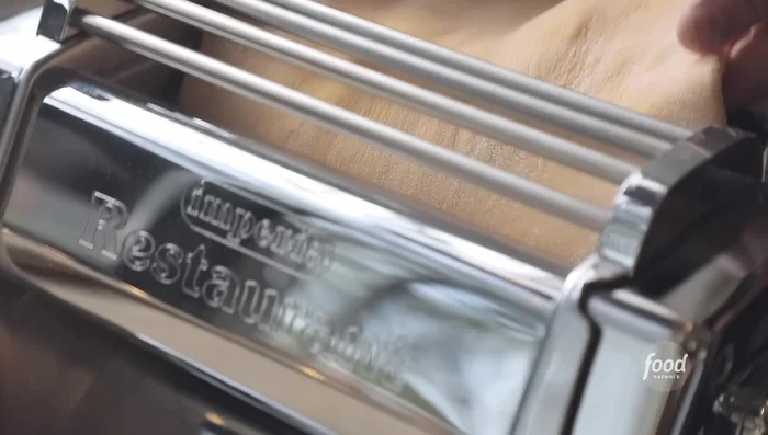 Roll out the pasta dough using a pasta machine or rolling pin.