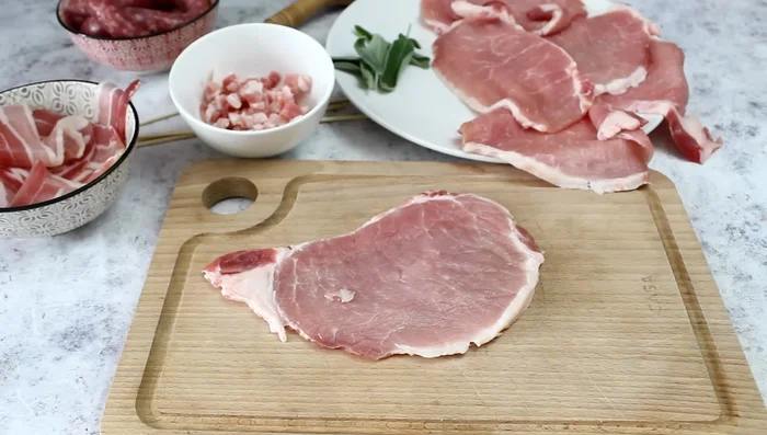 Place a sage leaf on each slice, add diced bacon, fold, and roll up each slice, wrapping with a bacon slice.