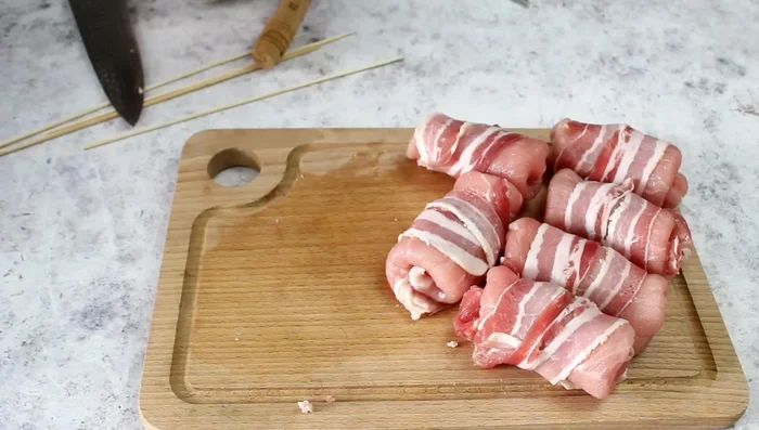 Assemble skewers by alternating the pork rolls with sausage pieces.