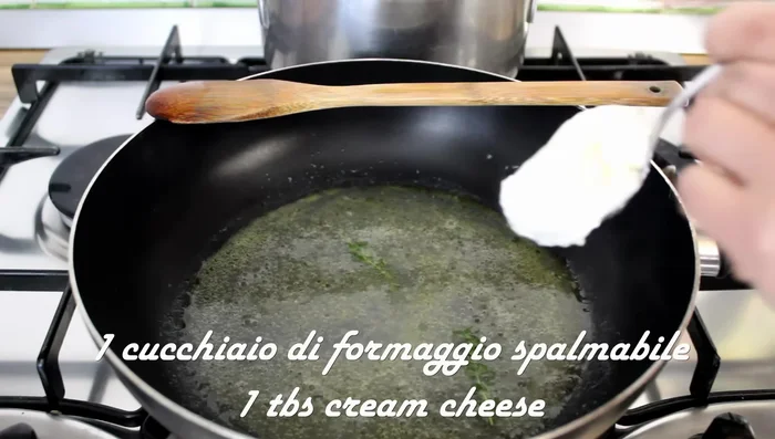 Add a spoonful of spreadable cheese and let it melt over low heat.