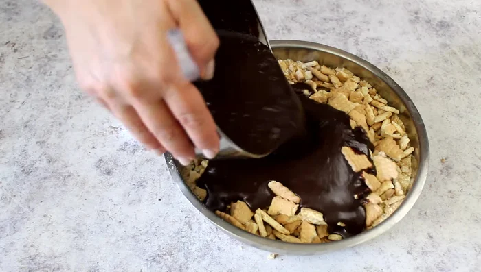 Combine the chocolate mixture with the crushed biscuits.
