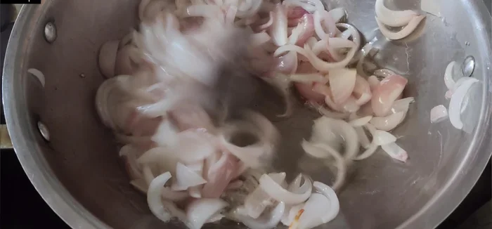 Add 4-5 crushed garlic cloves and fry until onions caramelize, stirring continuously. If onions start to burn, add 1 tablespoon of water.