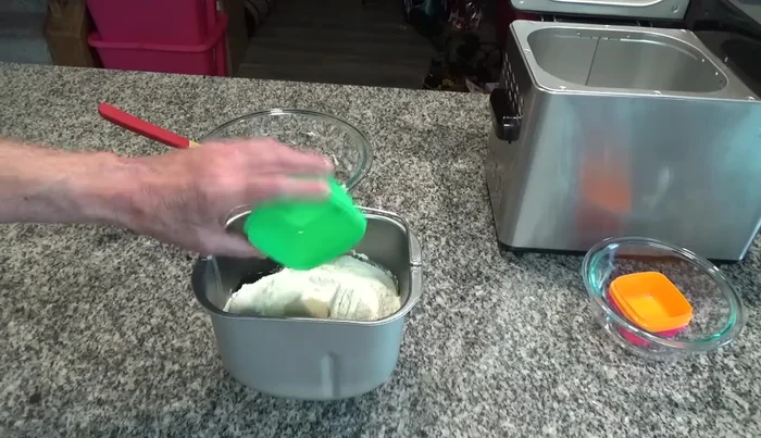 Put the bread pan into the bread machine and close the lid.