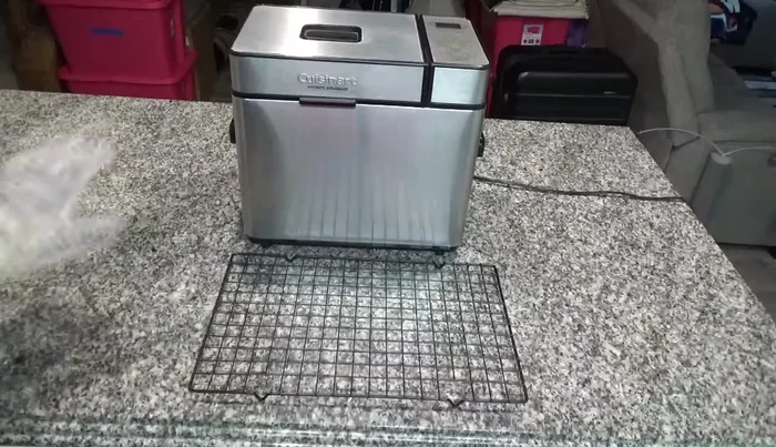 When the bread is done, remove the pan from the machine and let it cool for a few minutes.