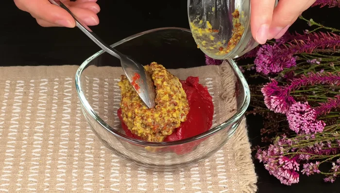 In a bowl, combine tomato paste, mustard, lemon juice, and sesame seeds.
