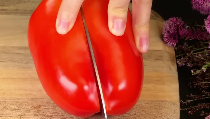 Add finely chopped red and yellow bell peppers and sliced cherry tomatoes to the skillet. Fry until softened.