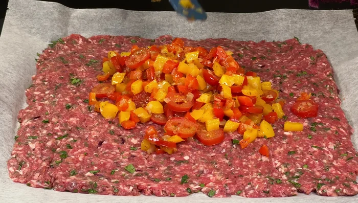 Evenly distribute the fried vegetables over the ground beef, leaving the edges empty.
