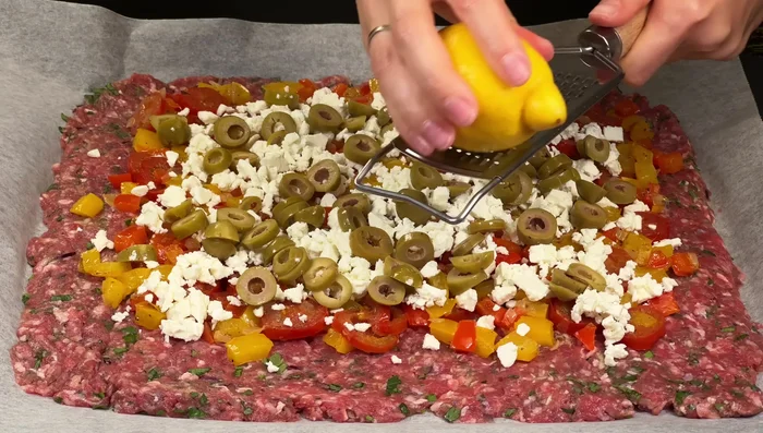 Grate lemon zest over the olives.