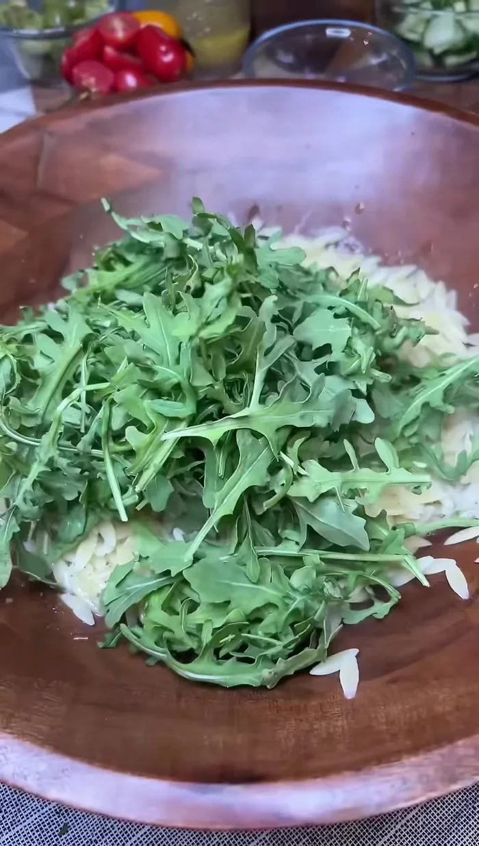 Add a handful of baby arugula and let it wilt and cool for about 10 minutes.