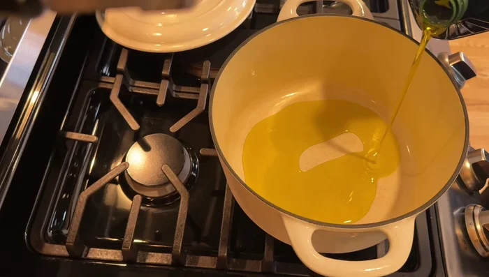 Heat olive oil in a pot over medium-high heat. Add onions, celery, and carrots. Cook until softened and onions are translucent.