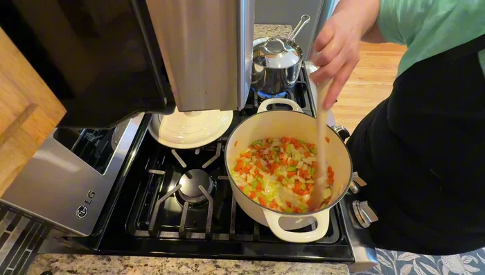 Add minced garlic and cook briefly. Then, stir in tomato paste.