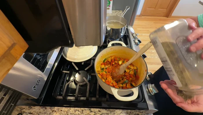 Add Italian seasoning, pepper, and salt to the pot. Stir in vegetable broth, green beans, and diced tomatoes.