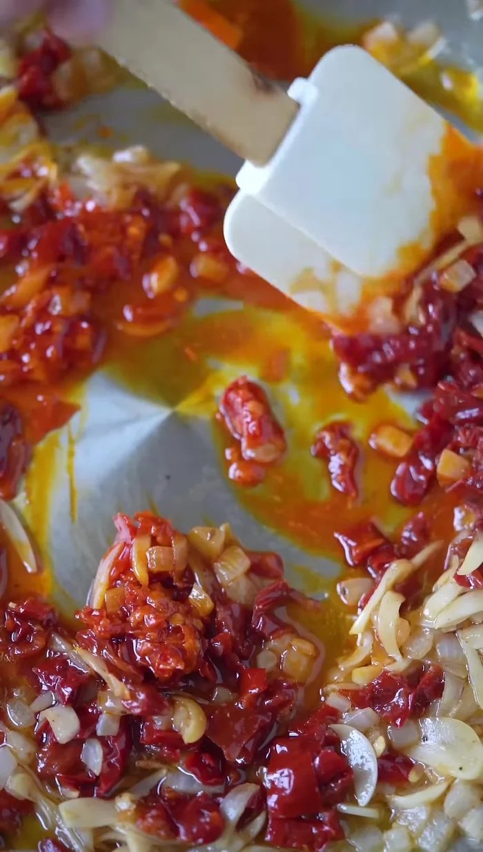 Add diced sun-dried peppers, Calabrian chilies, and capers.