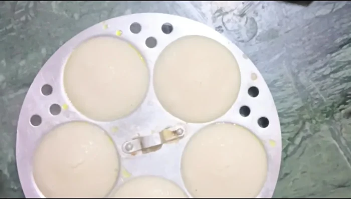 Carefully remove the cooked idlis.