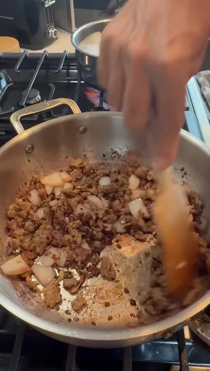 Return the sausage to the pan and let it absorb the wine.