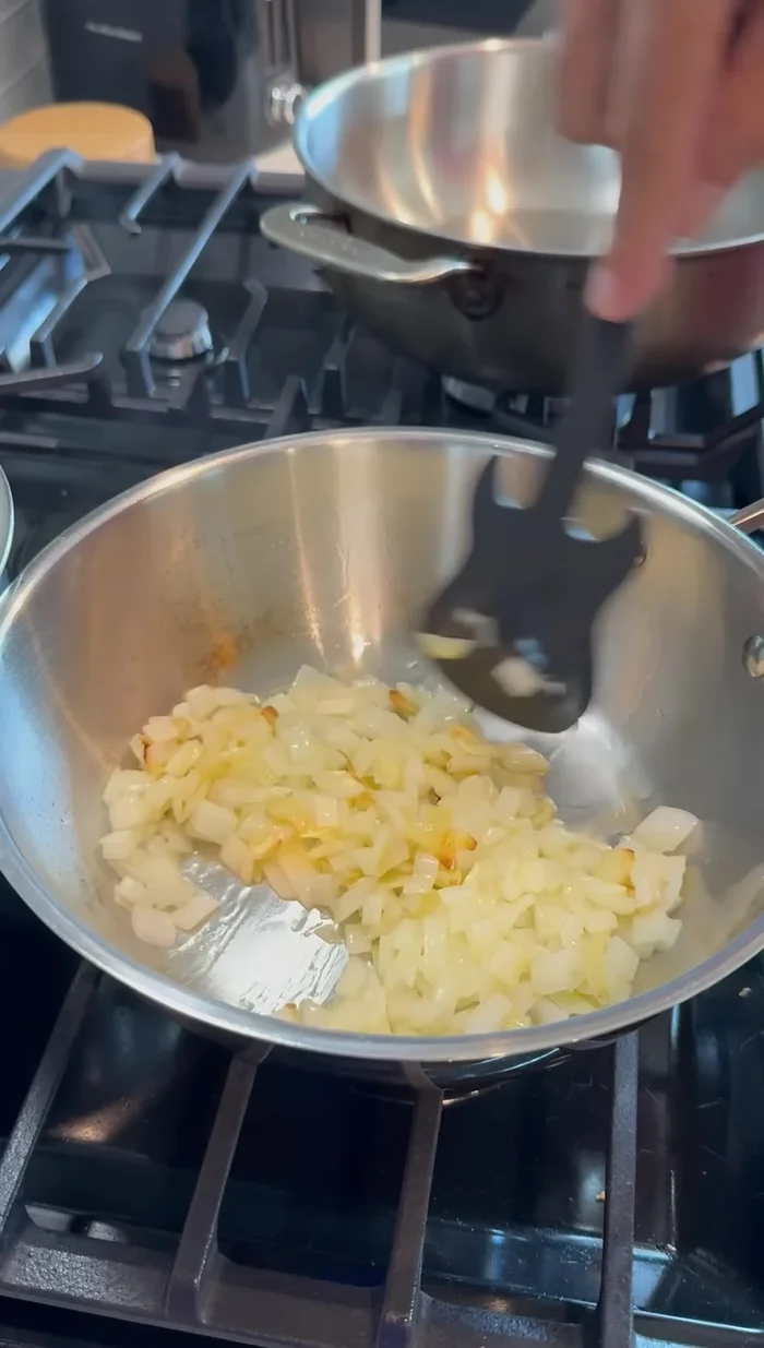 Add half of the diced onion and let it soften. Avoid burning.