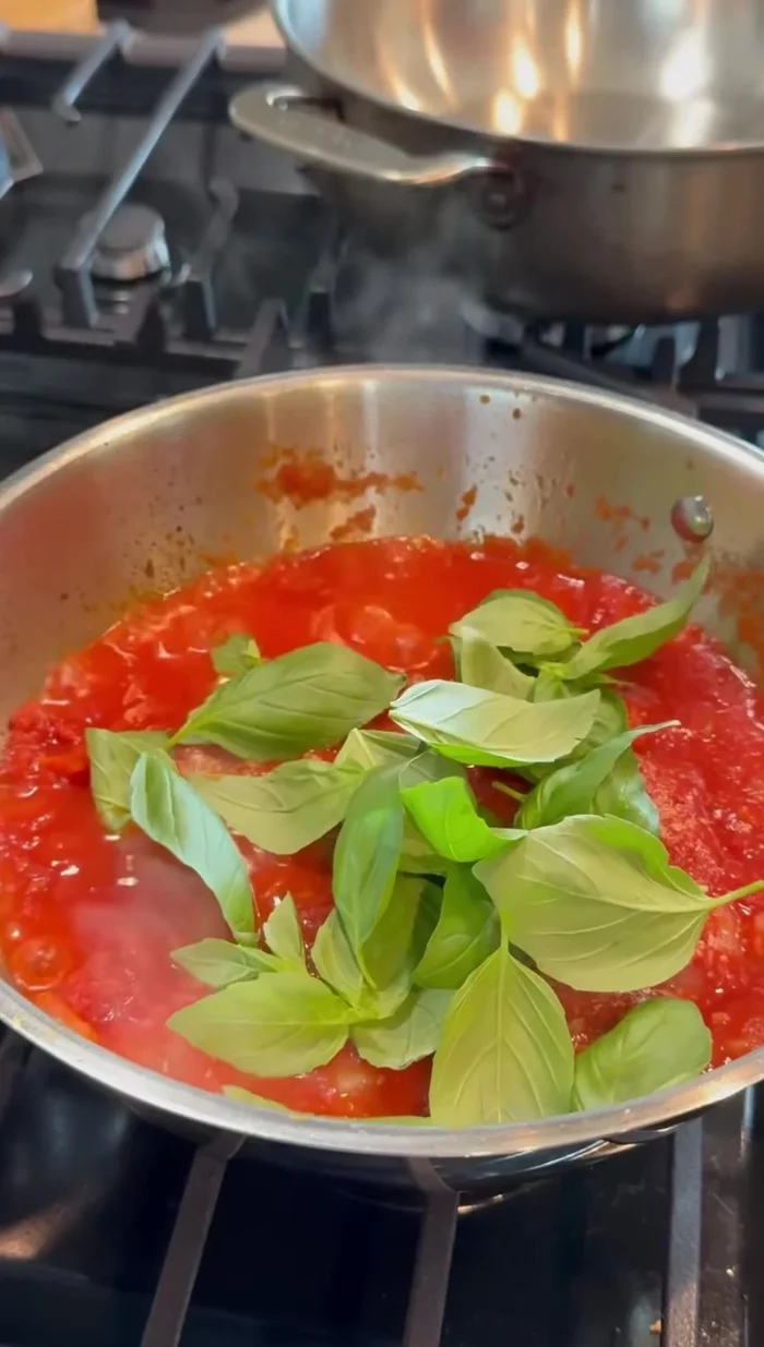 Stir in basil. Let the sauce simmer for a while to blend the flavors.