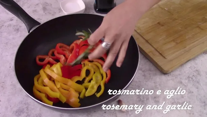 Put the peppers in a pan. Add rosemary, a clove of garlic (in its skin, broken), a drizzle of olive oil, and a pinch of salt. Cook until soft, adding a little water if necessary. [52.68, 74.92, 82.32, 90]