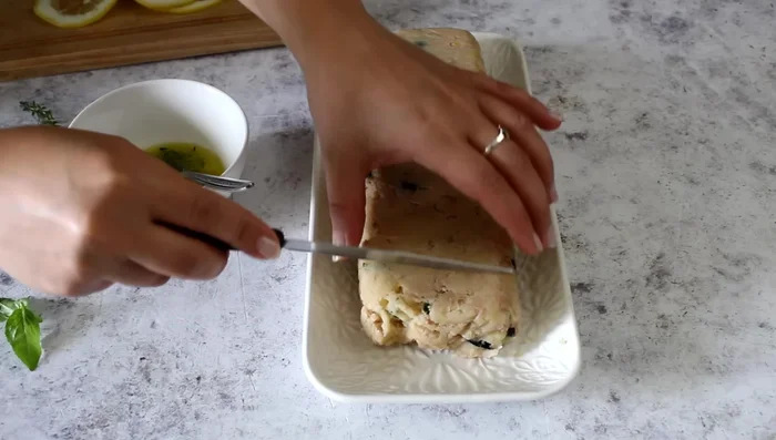 Slice the meatloaf, wetting the knife blade to prevent sticking.