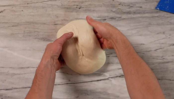 Fold and rest the dough: Wet your hands, lift, stretch, and fold the dough three times, with 5-10 minute rests between each fold.