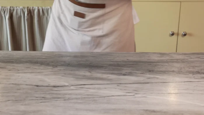 First bake: Add a light layer of tomato sauce. Bake directly on the oven floor for 7-8 minutes until the base is golden and firm.