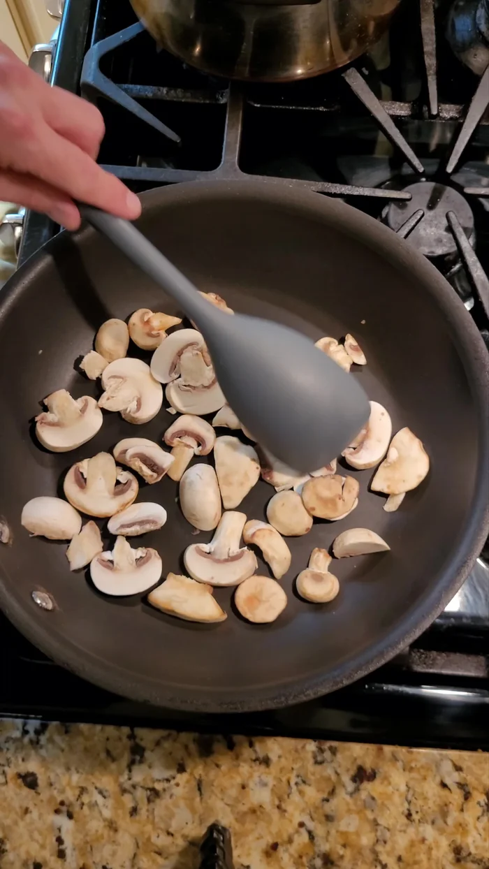 Add mushrooms to a preheated pan and cook until their moisture is sweated out and they brown. Set aside.