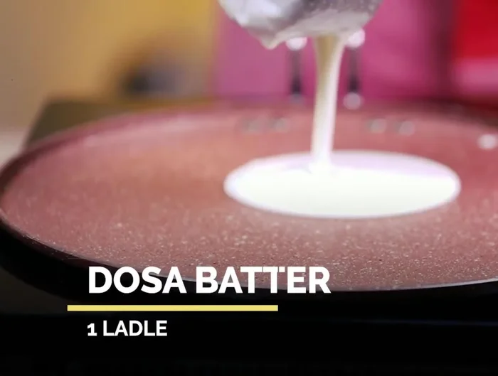 For the Italian Cheese Dosa: Heat a pan and brush with oil. Pour regular dosa batter and spread.