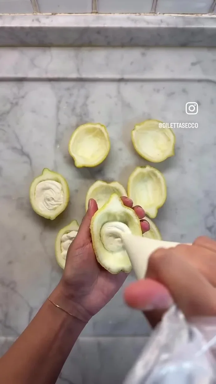 Fill lemon halves: first with cream cheese, leaving some space, then with lemon cream.