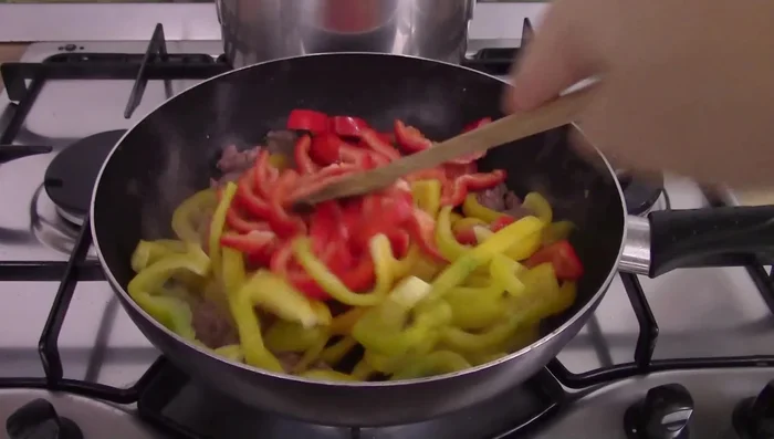 Add peppers to the pan, season with salt and water. Cover and cook until tender (about 20 minutes).