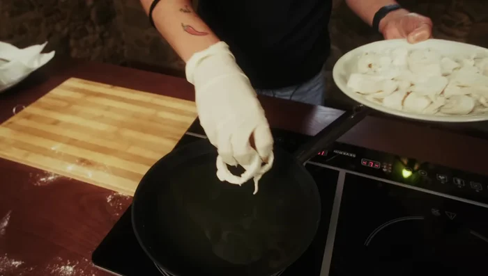 Fry the calamari in batches until golden brown (471.36)