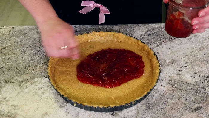 Spread jam evenly over the bottom crust.