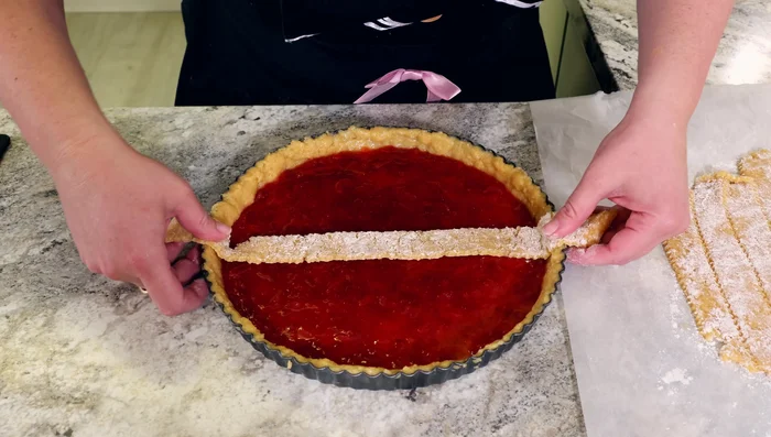 Arrange the dough strips in a lattice pattern (or crumble the dough over the top) . Trim excess dough.
