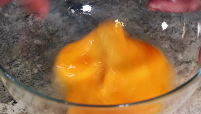 Whisk eggs in a separate bowl, then add vanilla extract.