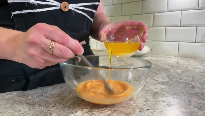 Add melted, cooled butter to the eggs and whisk.