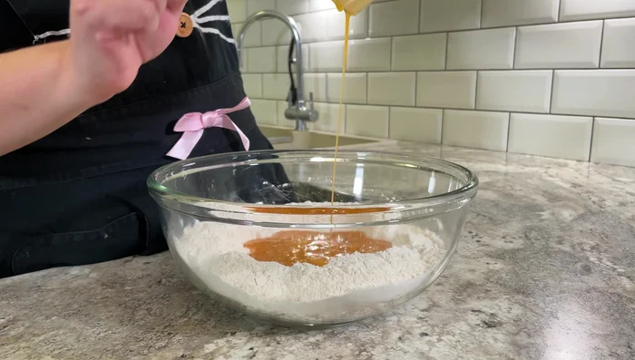 Make a well in the flour mixture, pour in the egg mixture. Gently incorporate flour into the wet ingredients. Don't overmix.