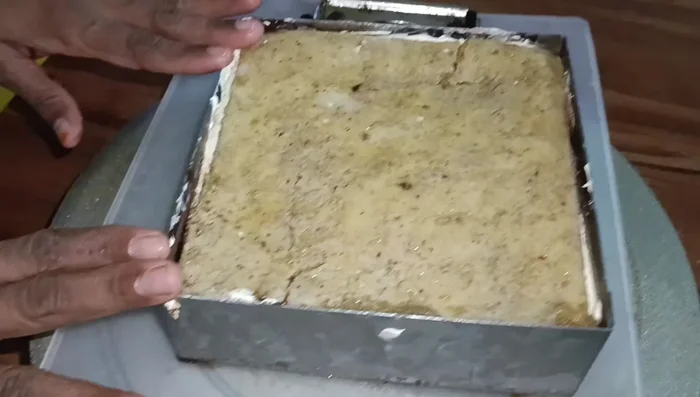 Glaze the frozen cake. Refrigerate for 10 minutes to set.